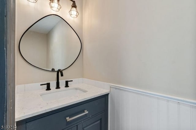 bathroom with wainscoting and vanity