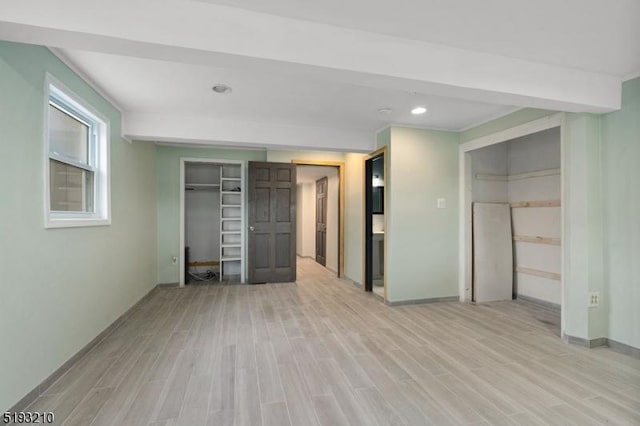 unfurnished bedroom featuring light wood-type flooring, recessed lighting, and baseboards