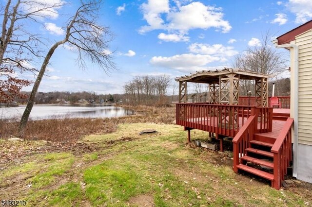 view of yard featuring a gazebo and a deck with water view