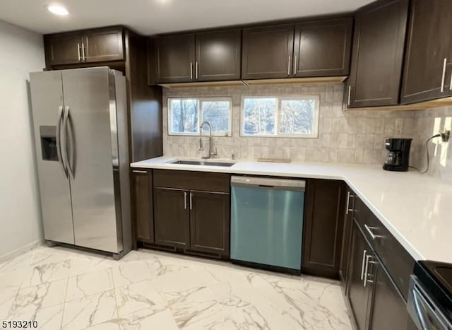 kitchen with dark brown cabinetry, appliances with stainless steel finishes, and a sink