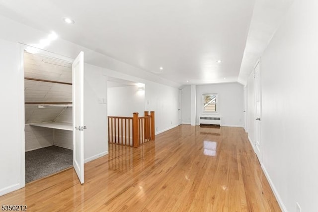 bonus room featuring radiator heating unit, recessed lighting, light wood finished floors, and baseboards