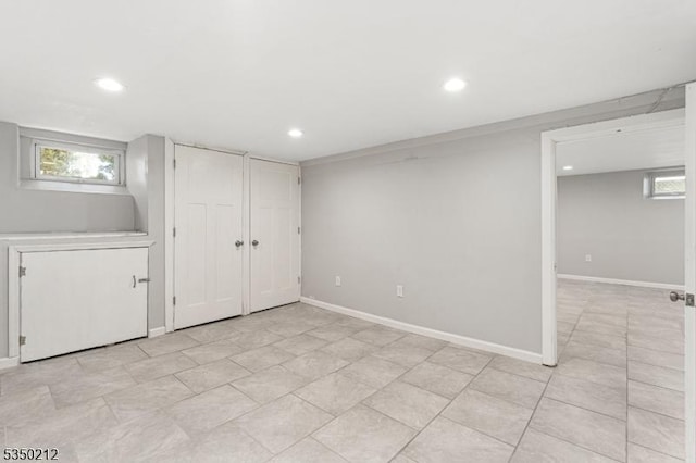 below grade area featuring baseboards and recessed lighting