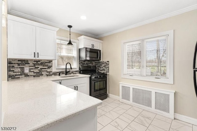 kitchen featuring stainless steel microwave, gas stove, white cabinetry, marble finish floor, and a sink