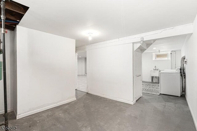 finished below grade area featuring washer / clothes dryer and baseboards
