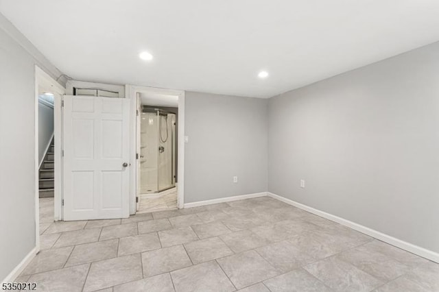 unfurnished bedroom with baseboards, recessed lighting, and ensuite bath