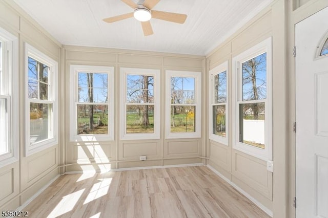 unfurnished sunroom with a decorative wall and plenty of natural light