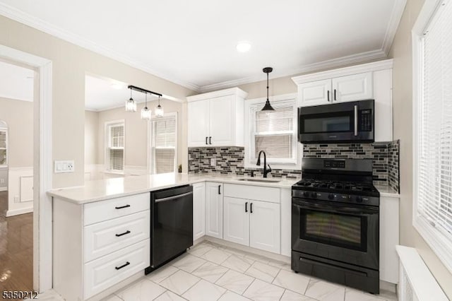 kitchen with a sink, ornamental molding, black gas stove, and dishwashing machine