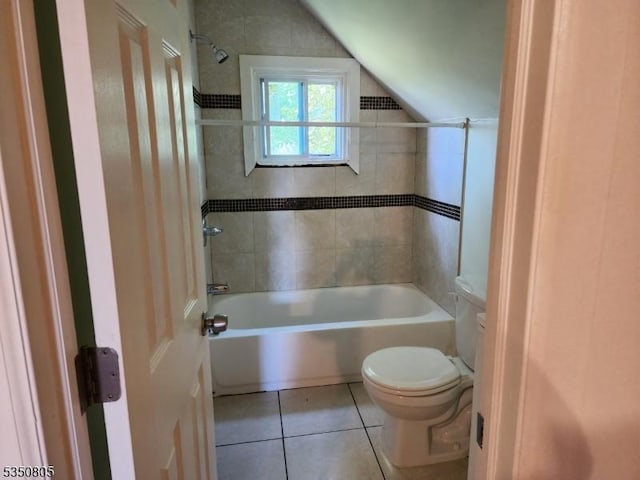 bathroom featuring tile patterned flooring, toilet, tub / shower combination, and lofted ceiling