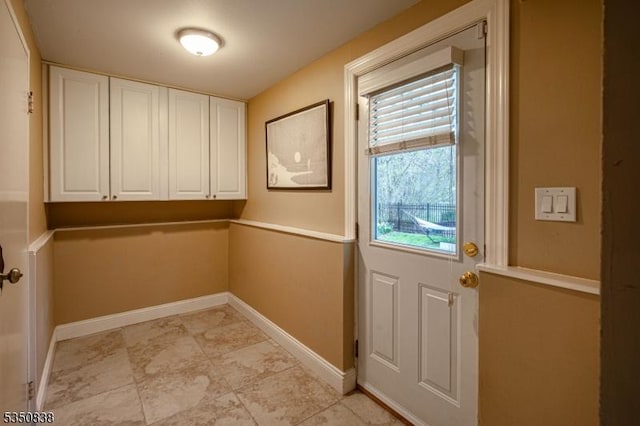 doorway to outside with baseboards