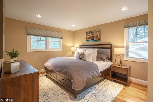 bedroom featuring baseboards, recessed lighting, and light wood-style flooring