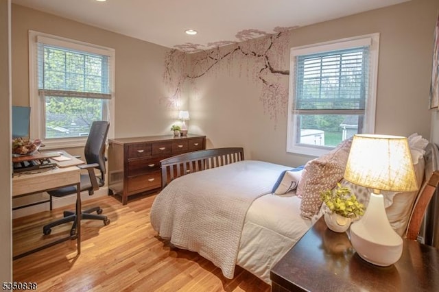 bedroom with recessed lighting, multiple windows, and light wood finished floors