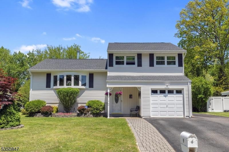 9 Harwich Rd, Mount Olive Twp, NJ 07836 - tri-level home with asphalt driveway, an attached garage, and roof with shingles