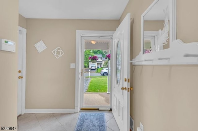 entrance foyer featuring light tile patterned floors and baseboards