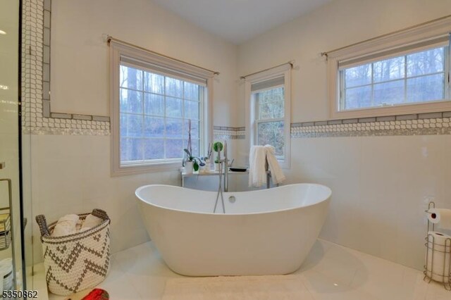 1 Dock Watch Hollow Rd, Warren Twp, NJ 07059 - full bathroom with tile walls, a soaking tub, tile patterned flooring, and a wainscoted wall