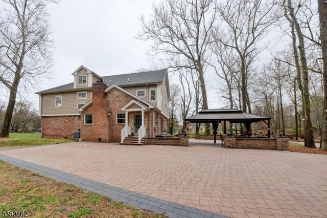 1 Dock Watch Hollow Rd, Warren Twp, NJ 07059 - view of front of house with a gazebo and brick siding