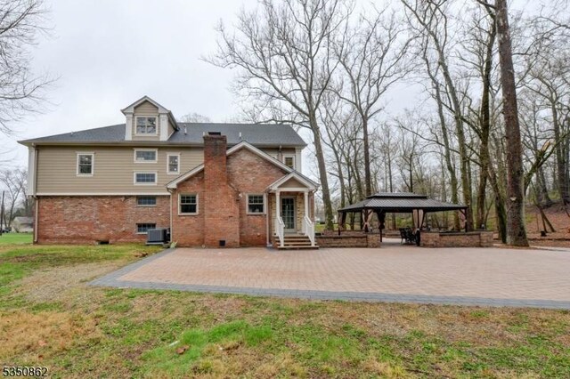 1 Dock Watch Hollow Rd, Warren Twp, NJ 07059 - rear view of property featuring a gazebo, a patio area, central AC, brick siding, and a lawn