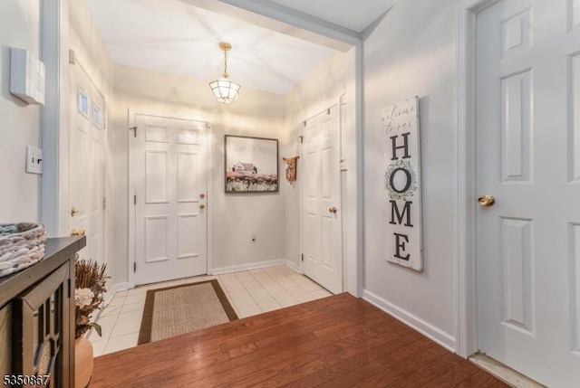 foyer entrance with baseboards and light tile patterned flooring