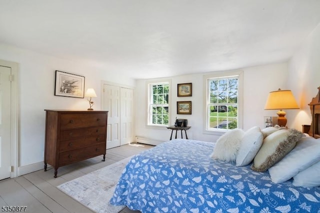 158 Rosemont Ringoes Rd, East Amwell Twp, NJ 08559 - bedroom featuring wood finished floors, baseboards, a closet, and a baseboard radiator