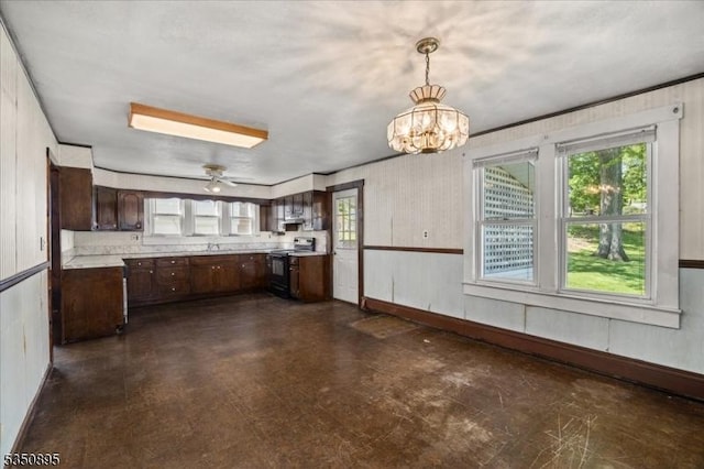 kitchen with black electric range oven, dark brown cabinets, healthy amount of natural light, and light countertops