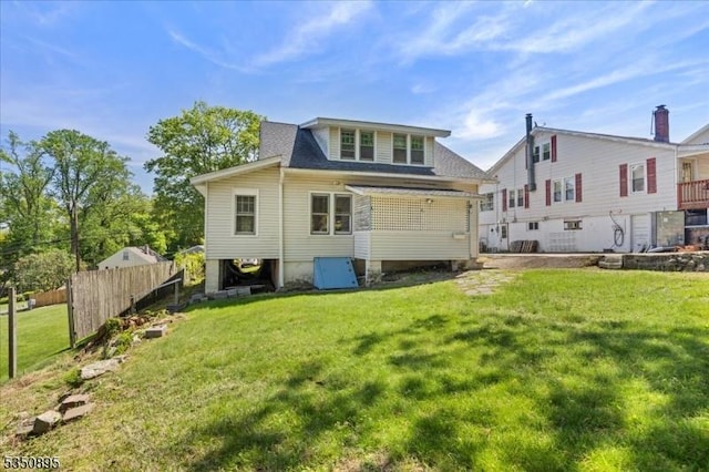 rear view of house featuring a shingled roof