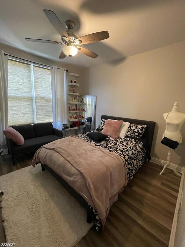 bedroom featuring baseboards, a ceiling fan, and wood finished floors