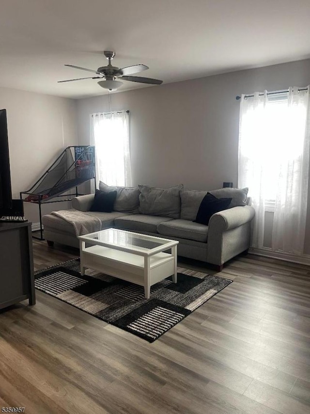 living room featuring wood finished floors and ceiling fan