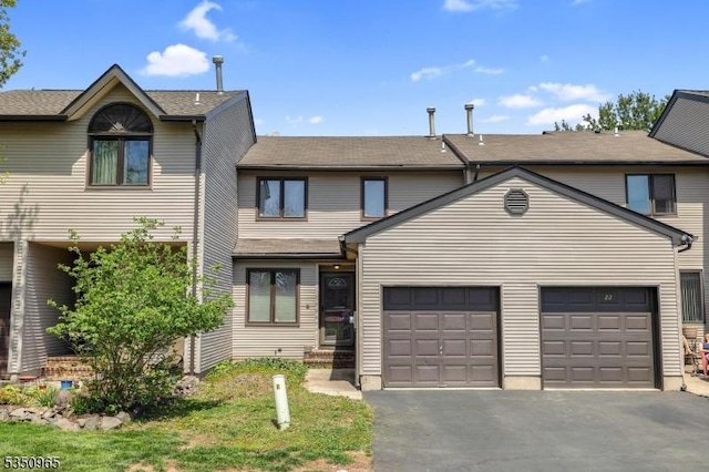 view of front of house with an attached garage and aphalt driveway