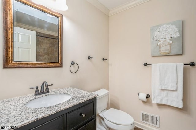 bathroom featuring ornamental molding, vanity, and toilet