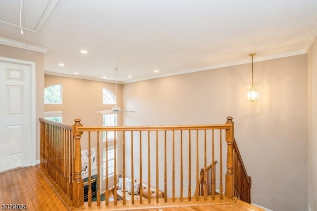 stairway with attic access, hardwood / wood-style flooring, crown molding, recessed lighting, and ceiling fan