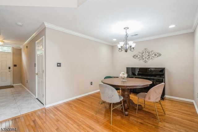 dining area with a chandelier, ornamental molding, baseboards, light wood-type flooring, and recessed lighting