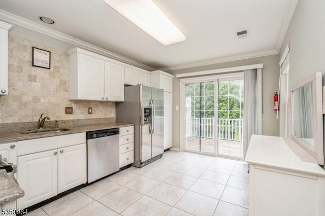 kitchen with stainless steel appliances, a sink, ornamental molding, backsplash, and white cabinets