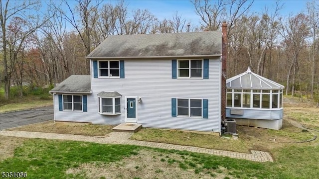 187 Mount Horeb Rd, Warren Twp, NJ 07059 - view of front of home with a front lawn, a chimney, a sunroom, and central AC unit