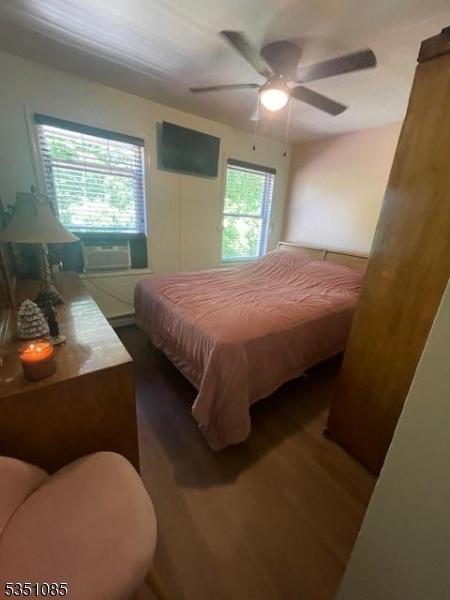 26 Wyker Rd, Franklin Boro, NJ 07416 - bedroom featuring cooling unit, wood finished floors, and ceiling fan