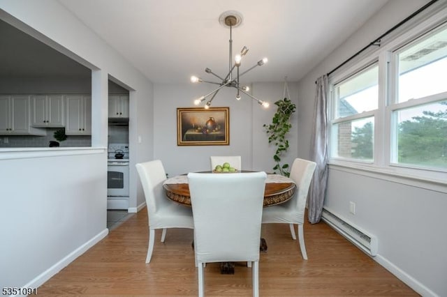 807 Eves Dr Unit 3P, Hillsborough Twp, NJ 08844 - dining room with a baseboard radiator, a chandelier, light wood finished floors, and baseboards