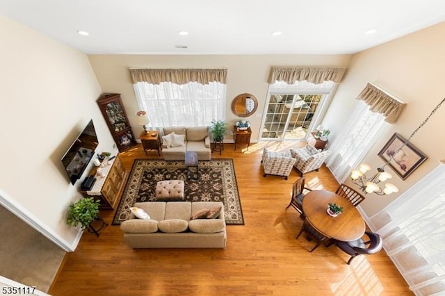 living area featuring baseboards, recessed lighting, and wood finished floors