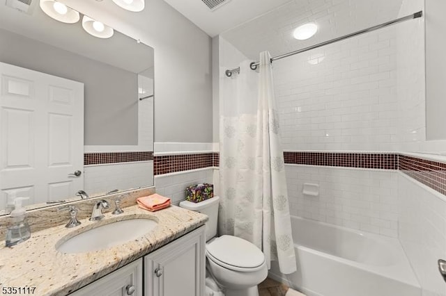 full bath with shower / bath combination with curtain, visible vents, tile walls, vanity, and toilet