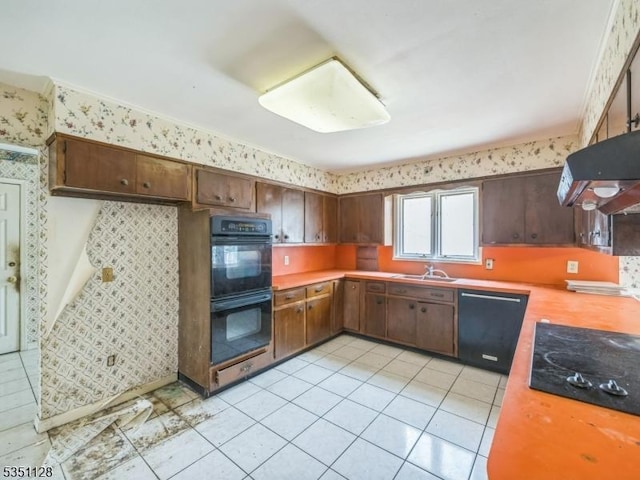 kitchen featuring a sink, wallpapered walls, black appliances, light tile patterned floors, and light countertops