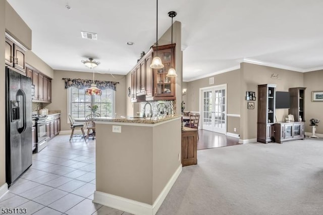 kitchen with black fridge with ice dispenser, electric stove, baseboards, glass insert cabinets, and plenty of natural light