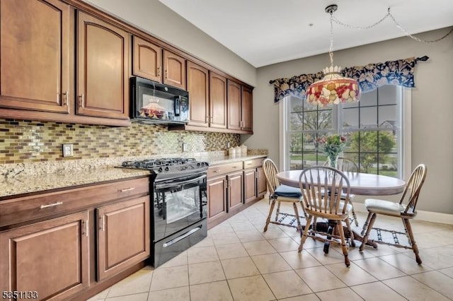 kitchen featuring black appliances, decorative backsplash, light stone countertops, and brown cabinetry