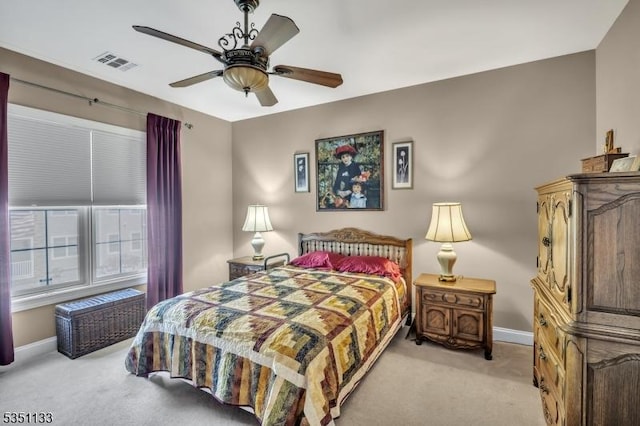 bedroom with light colored carpet, baseboards, and ceiling fan