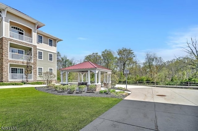 view of community with a gazebo and driveway