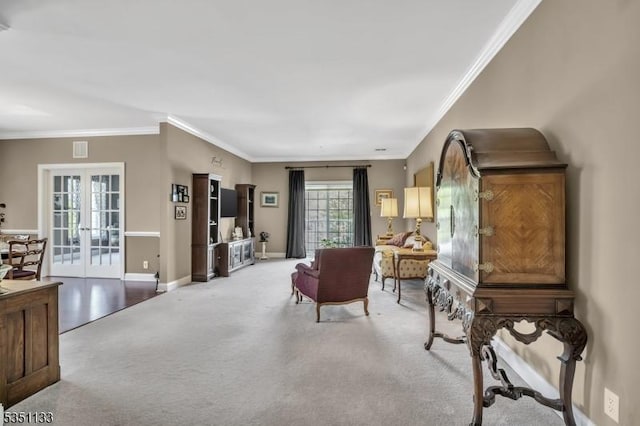 sitting room featuring ornamental molding, light colored carpet, french doors, and baseboards