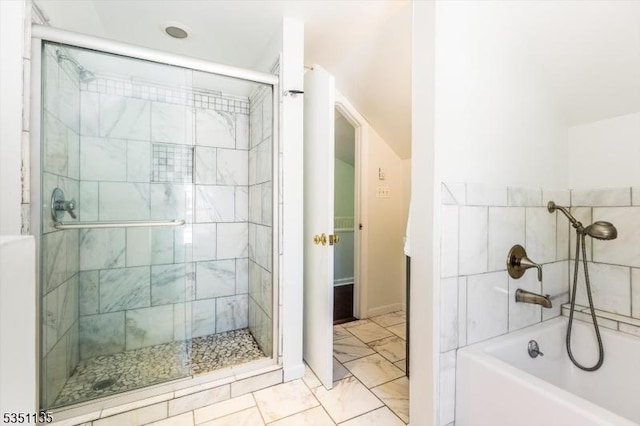full bathroom featuring baseboards, a washtub, a stall shower, and marble finish floor