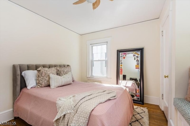 bedroom featuring baseboards, ceiling fan, and wood finished floors