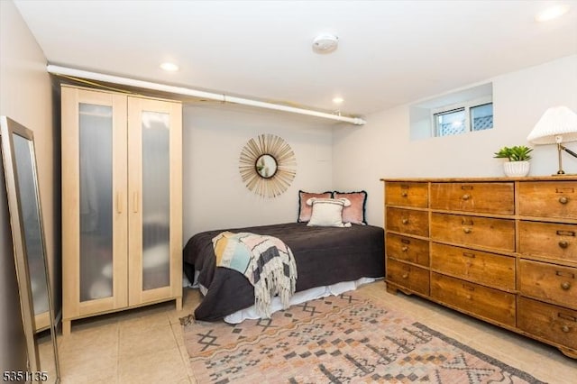bedroom with tile patterned flooring and recessed lighting