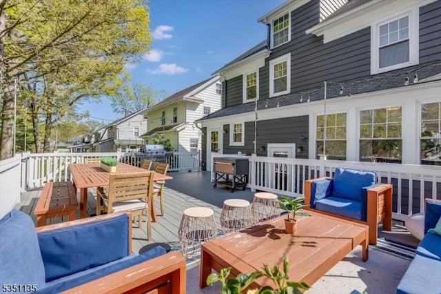 deck featuring outdoor dining space and outdoor lounge area