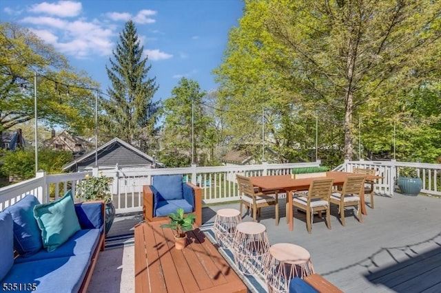 wooden terrace featuring outdoor lounge area and outdoor dining space