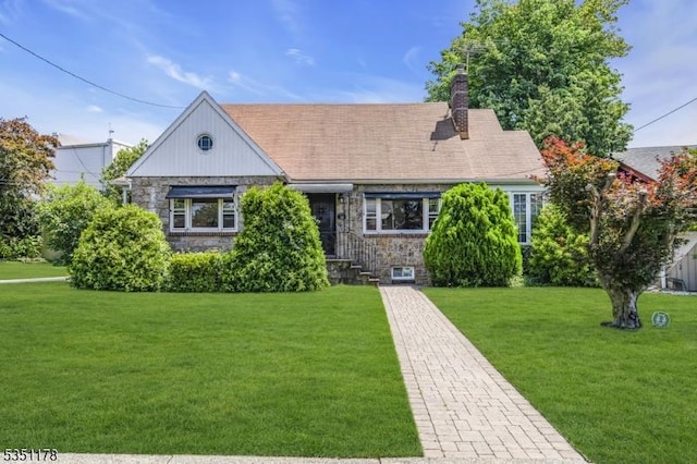 106 Anderson St, Raritan Boro, NJ 08869 - view of front facade featuring stone siding, a front yard, and a chimney