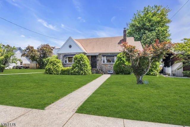 106 Anderson St, Raritan Boro, NJ 08869 - view of front of home featuring a front lawn, a chimney, and stone siding