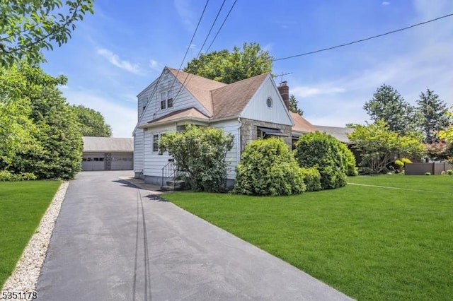 106 Anderson St, Raritan Boro, NJ 08869 - view of front of property with a chimney, a front yard, an outdoor structure, and a detached garage